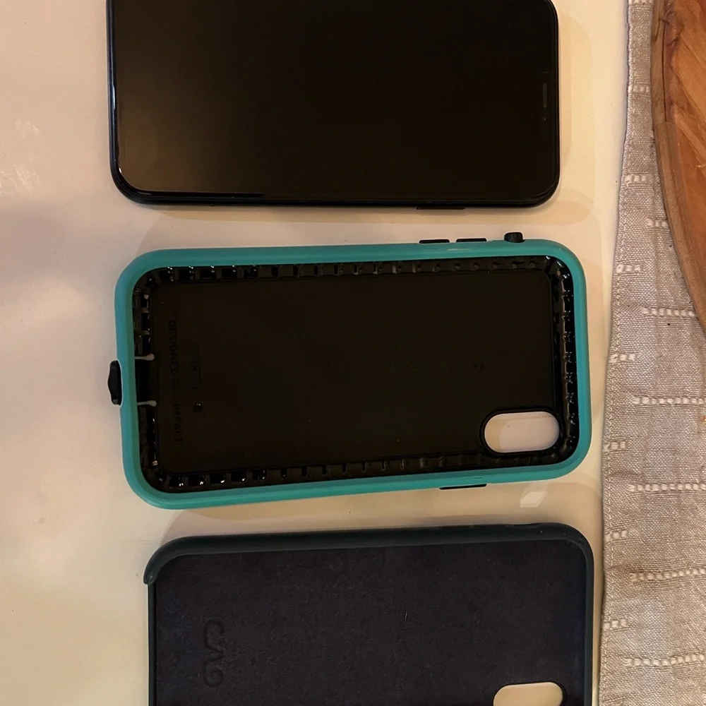 Apple Black XR - 128 GB, unlocked phone with two cases.